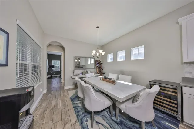 a bedroom with a bed a dresser and a flat screen tv