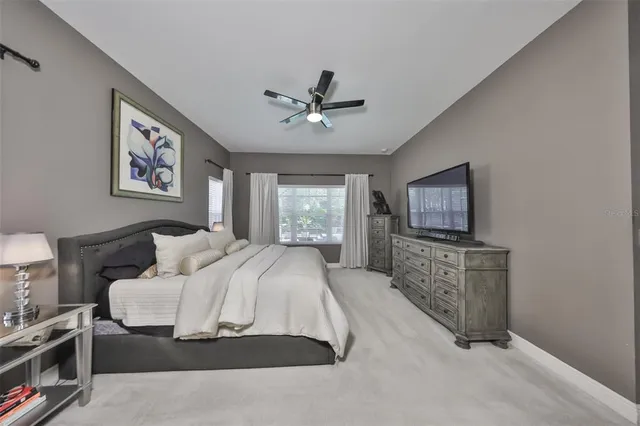 a living room with a bed furniture and a flat screen tv