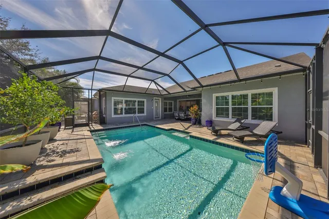 a view of a patio with table and chairs under an umbrella