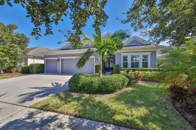 a view of a swimming pool with a bench in front of house