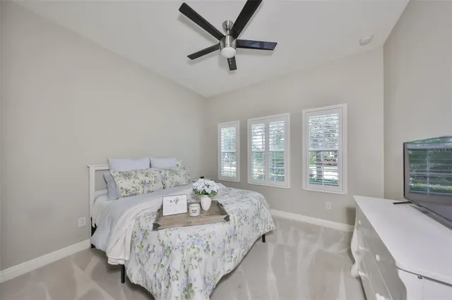 a bedroom with a bed furniture and a flat screen tv