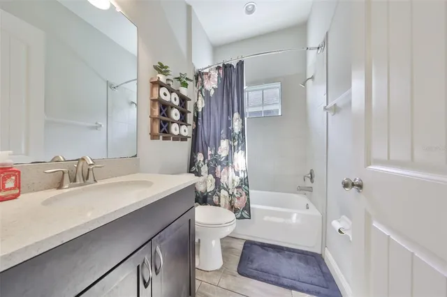 a view of a dining room and livingroom with furniture wooden floor and a rug