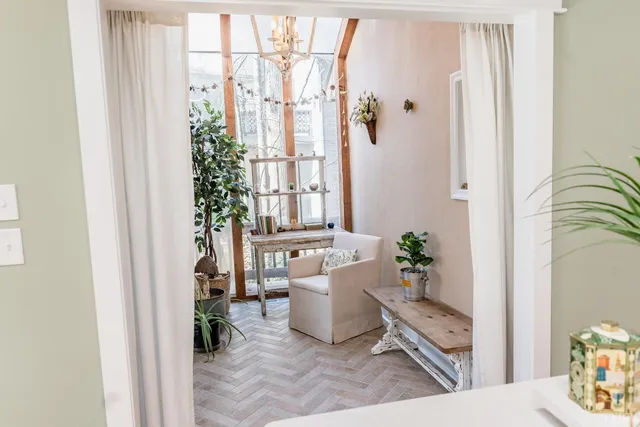 a white toilet sitting next to a bathroom sink and a mirror