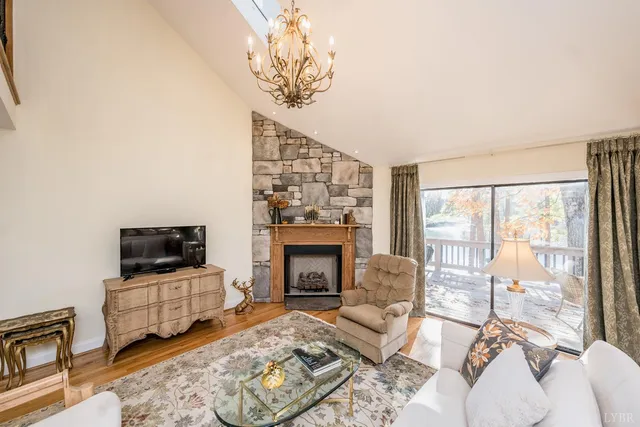 a living room with fireplace furniture and a rug