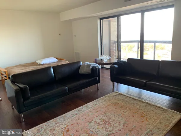 a living room with a couch and a large window