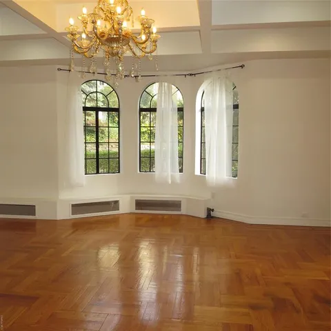 a view of an empty room with windows
