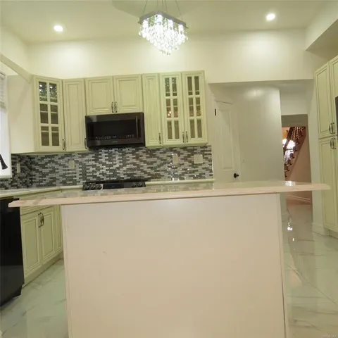 a view of kitchen with granite countertop cabinets and sink