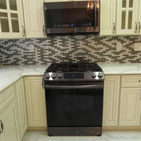 a stove top oven sitting inside of a kitchen