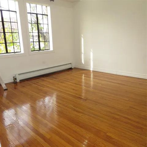 a view of room with wooden floor
