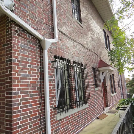 a view of a brick house with many windows