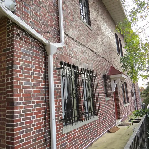 a view of a brick house with many windows