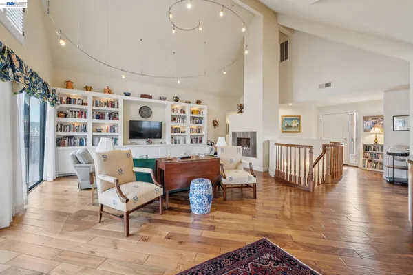 a large kitchen with kitchen island a large window a sink and stainless steel appliances