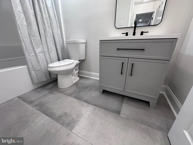 a bathroom with a sink toilet and mirror