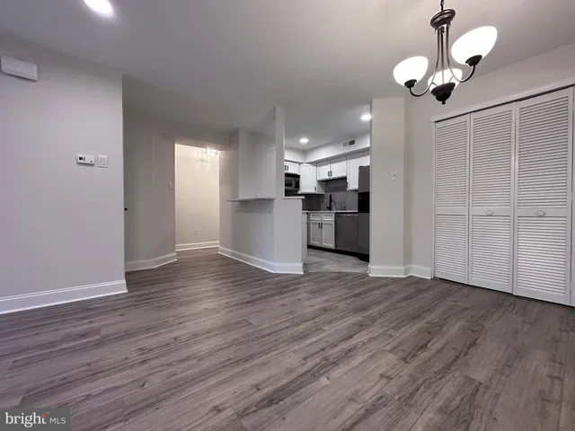 a view of a kitchen with a dishwasher cabinets and wooden floor
