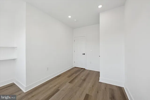 a view of a room with wooden floor