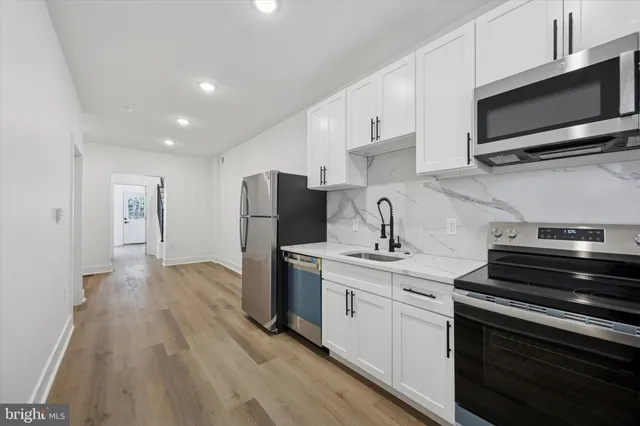 a kitchen with a sink stainless steel appliances and cabinets