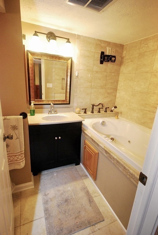 105 Helberg Road Springfield, MA 01128 - Photo 15 of 29 a spacious bathroom with a tub sink and mirror