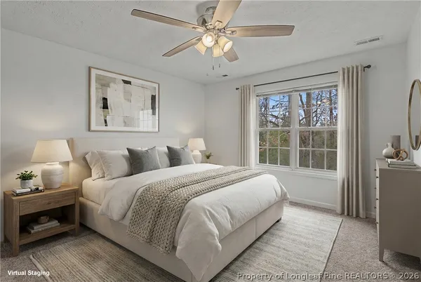 a bedroom with a large bed and a window