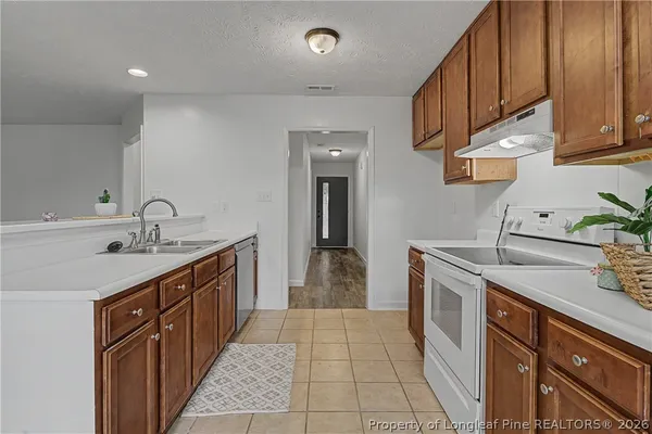a kitchen with granite countertop a sink and cabinets