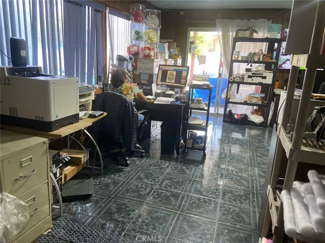 a view of a workspace with furniture and a window