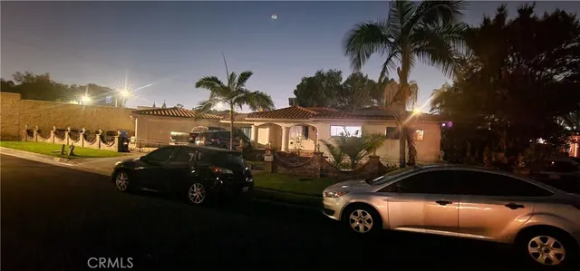 a couple of cars parked in front of a house