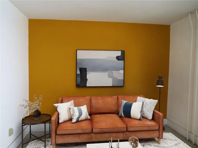 a blue couch sitting in a bathroom next to a blue wall