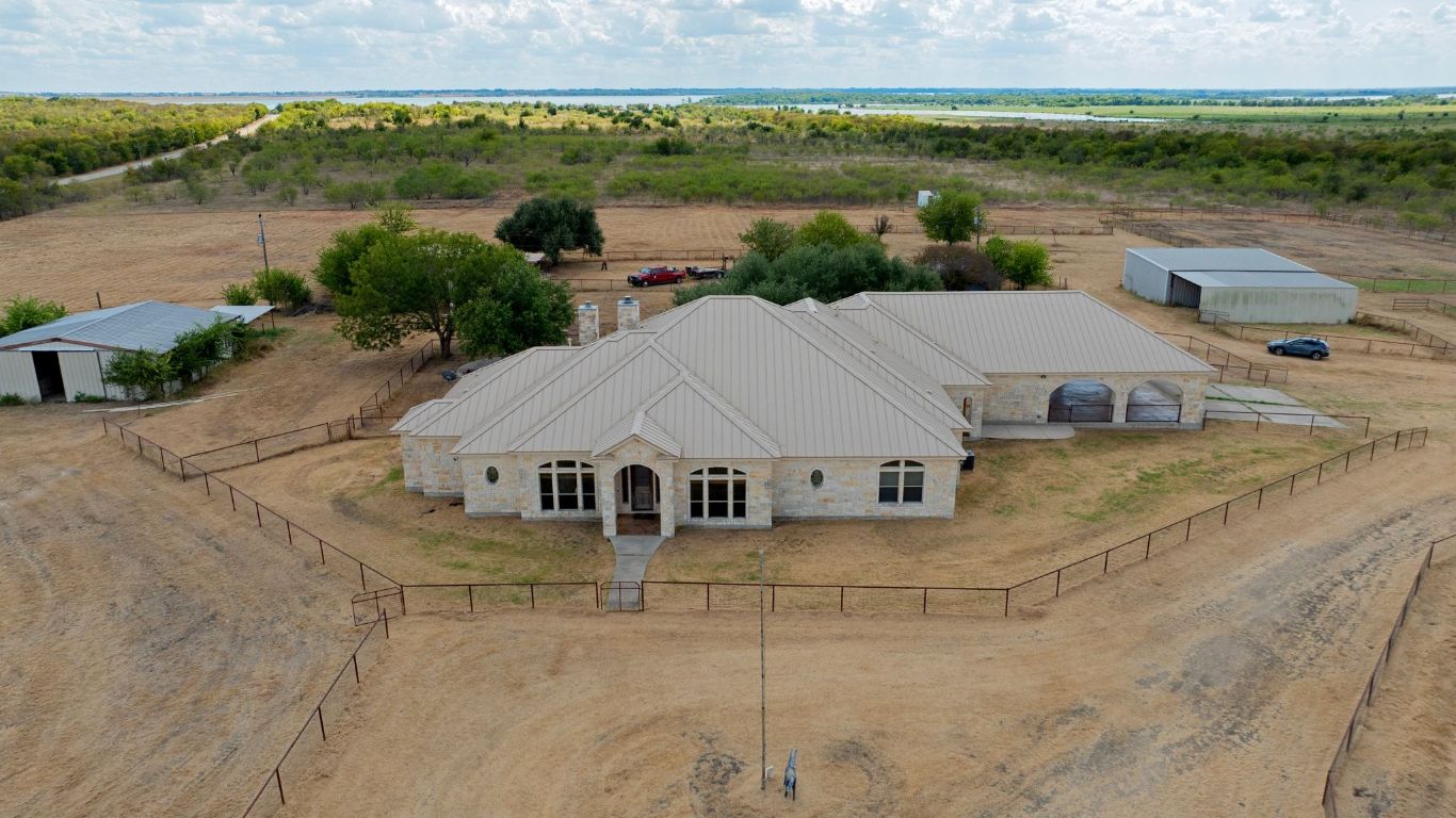 an aerial view of a house with a lake view