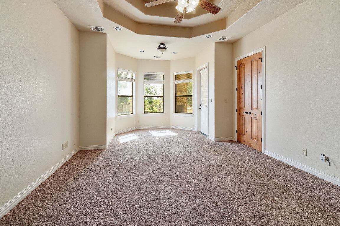 22300 Farm To Market Road 971 Granger, TX 76530 - Photo 16 of 37 an empty room with windows and ceiling fan