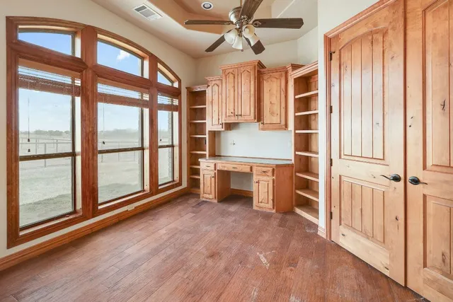 a bathroom with a granite countertop double vanity sink a mirror and a shower