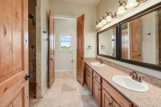 a view of a house with a yard and a large tree