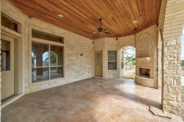 a view of a porch with a table and chairs