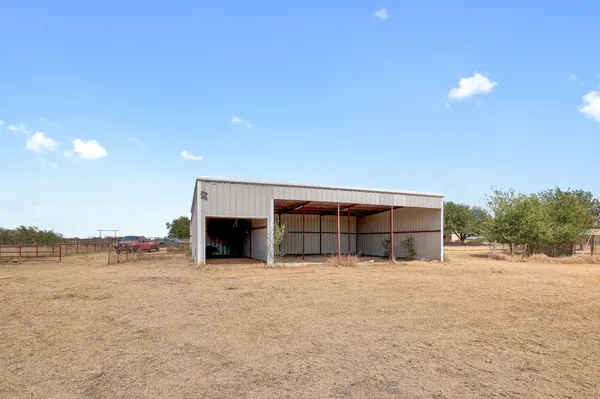a view of a house with a yard and a garage