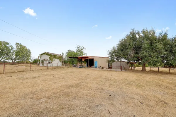 a front view of house with yard and trees