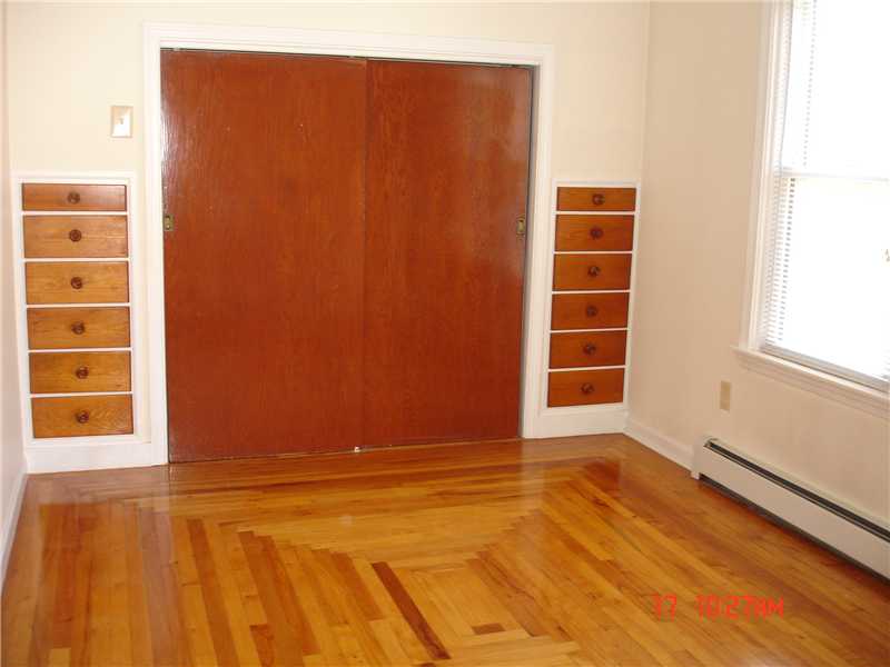 44 Pine Street Woonsocket, RI 02895 - Photo 7 of 10 Bedroom. Front bedroom features hardwoods and built ins with large closet.