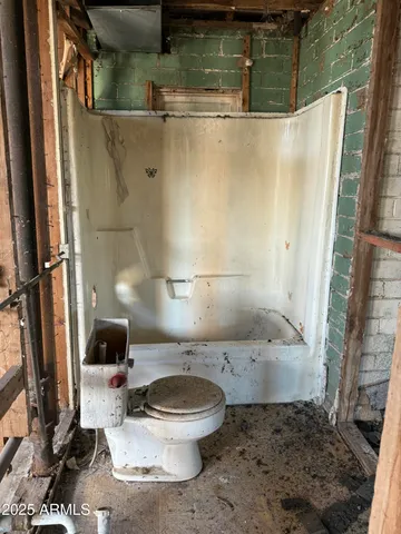 a view of water heater room with a chair