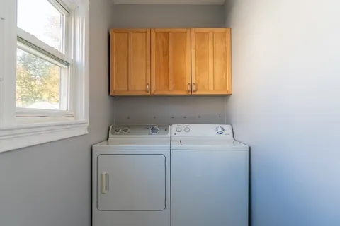 a kitchen with stainless steel appliances granite countertop a stove a refrigerator and a window