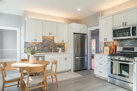 a kitchen with stainless steel appliances a refrigerator stove microwave and cabinets