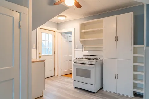 a view of a kitchen from a hallway