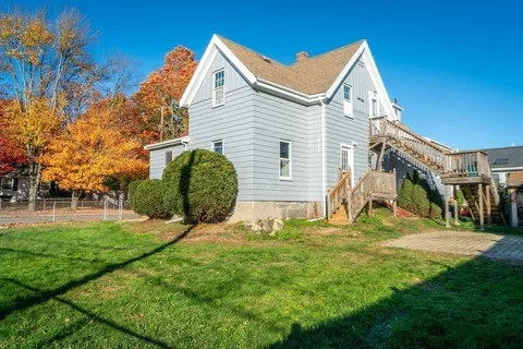 a front view of a house with a yard garage and outdoor seating