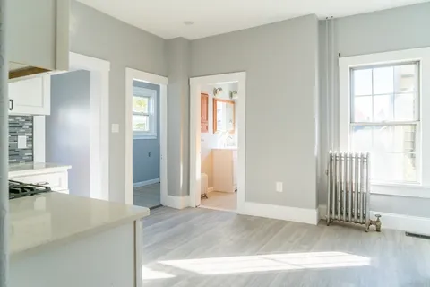 a living room with furniture a table and a potted plant