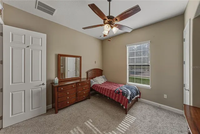a living room with furniture a ceiling fan and a window