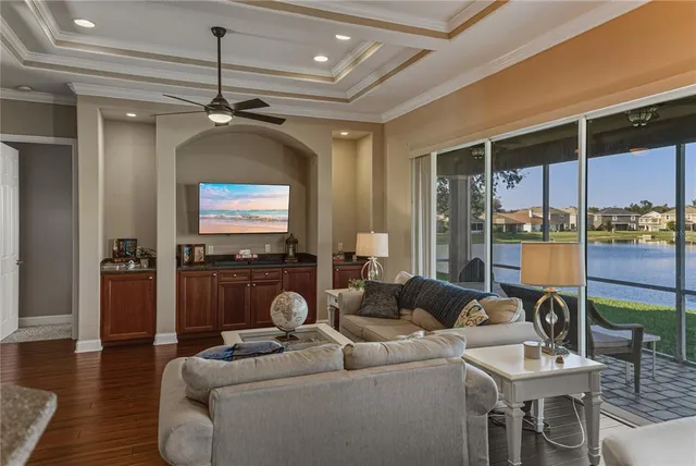 a dining room with wooden floor a chandelier a wooden table and chairs