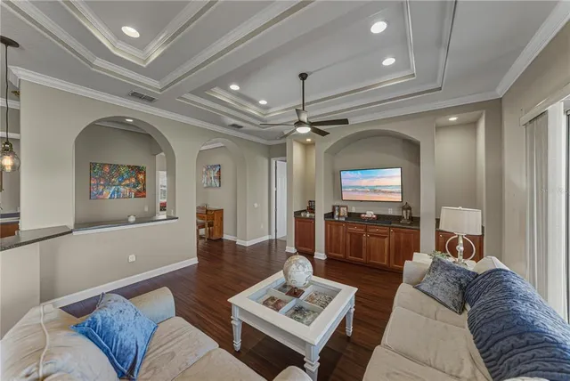 a dining room with furniture a chandelier and wooden floor