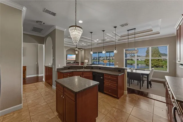 a bathroom with a granite countertop sink a mirror a bathtub and shower