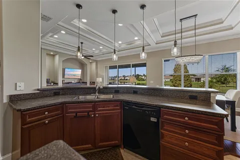 a bathroom with a granite countertop sink a toilet and a mirror
