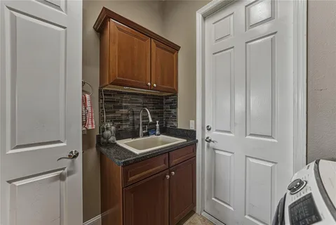 a view of a house with a yard and potted plants