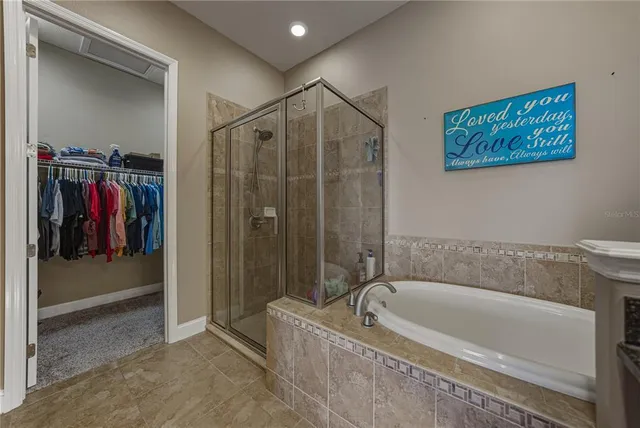 an aerial view of a house with a garden and lake view