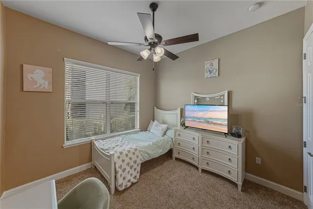 a bathroom with a granite countertop sink a toilet a mirror a vanity and shower