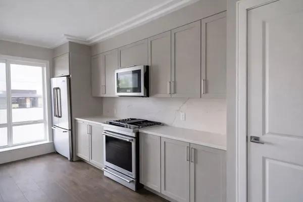 a view of a kitchen with electric appliances