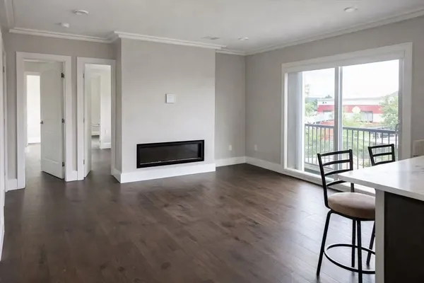 a view of room with window and wooden floor